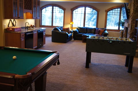 Spacious lower level family room with wet bar, pool table and foosball table.