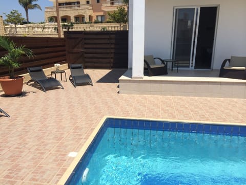 Large sun drenched pool terrace surrounds the pool