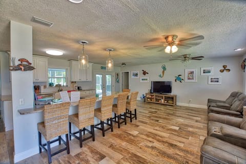 From front door you have a large island with seats/kitchen and living room area.