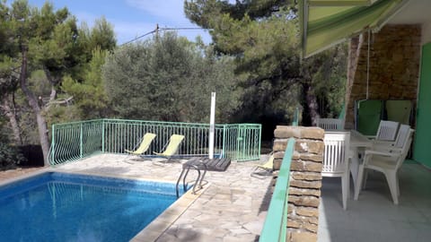 The south terrace and the pool in its green setting