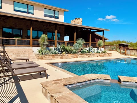 Gorgeous covered patio and landscaping overlooking the pool