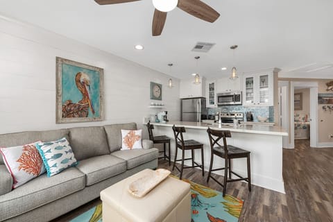 Relax in the cozy elegance of our living room, where the decor reflects the sandy shores.