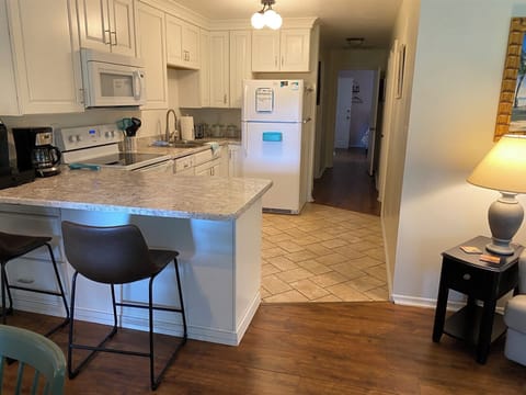 Newly renovated kitchen with Keurig and large coffee maker.