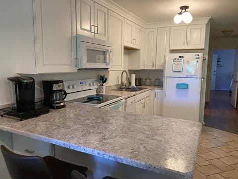 Kitchen with view of bedrooms and bathrooms down the hallway.