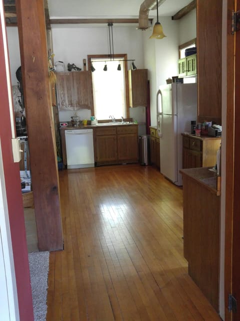 The entry's maple flooring saved from a country school flows into the kitchen.