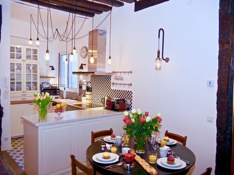Well equipped open plan designer kitchen with marble top and dining area