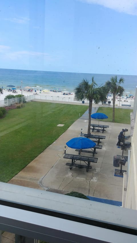 Grill and picnic area with new tables and umbrellas as viewed from my balcony.