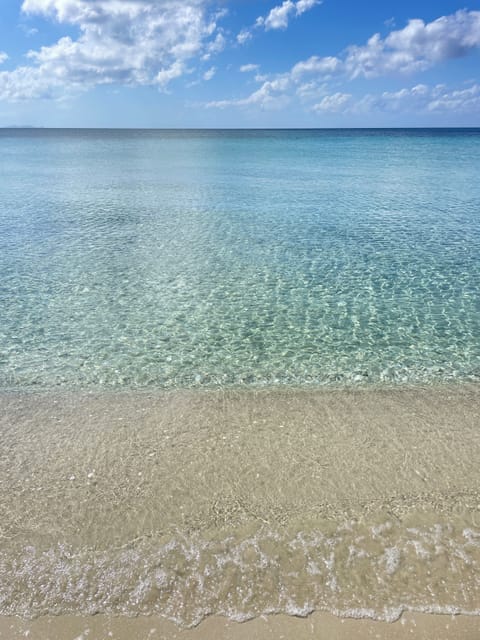 On the beach, white sand, sun loungers, beach towels