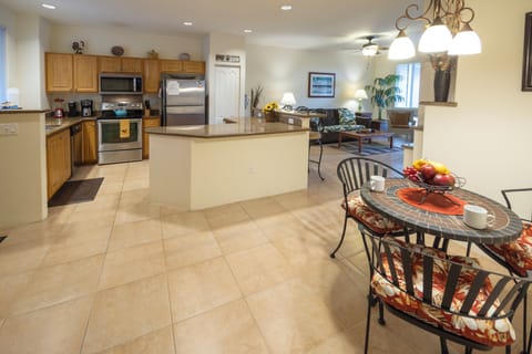 Luxurious open-concept living, kitchen, and dining area with soaring ceilings