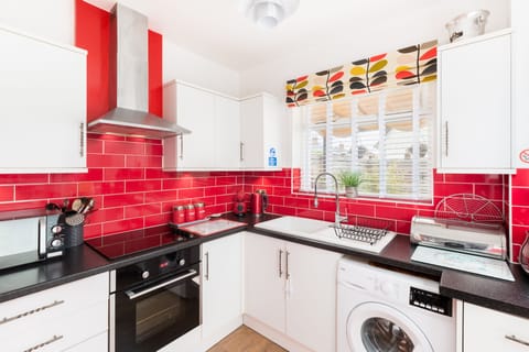 Kitchen with window over pretty  and private Courtyard garden with undercover. 