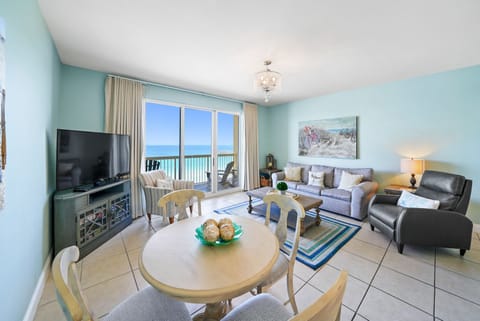 Relax in your bright living space with stunning ocean views through floor-to-ceiling windows. Your comfortable seating awaits for peaceful evenings.