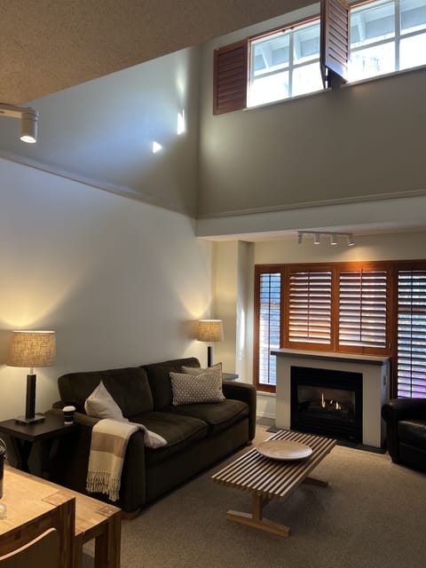 Living area features lofted ceilings, gas fireplace ,&aNew 65” Smart TV 