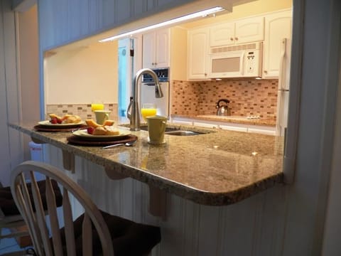 Fully equipped kitchen with granite counters.