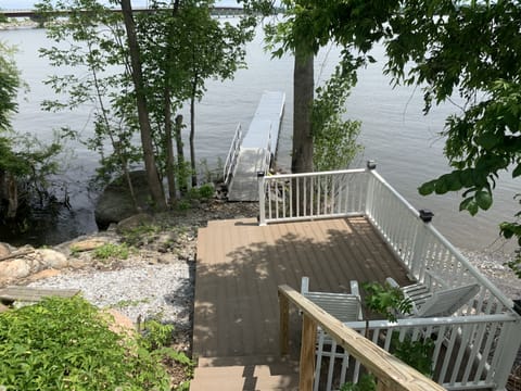 Newer deck and floating dock with fire pit to the left and Rowboat for your use 