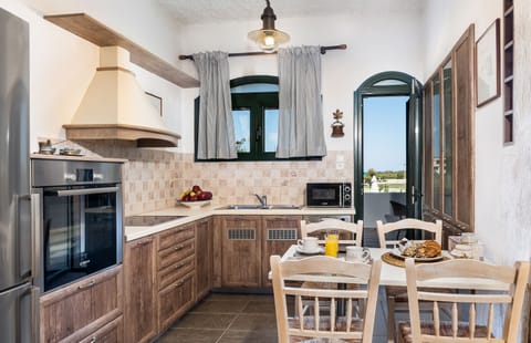 The kitchen is fully equiped with modern household appliances.