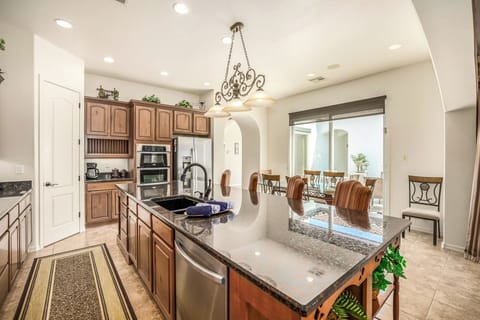 Bar stools in addition to 6 chairs at the breakfast table.