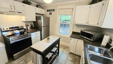 Well stocked kitchen for meal preparation with new refrigerator and oven in 2023