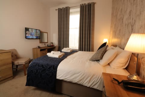 Desk, iron/ironing board, bed sheets