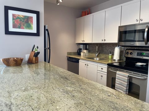 Well appointed kitchen with utensils, pots and pans.  Granite counters