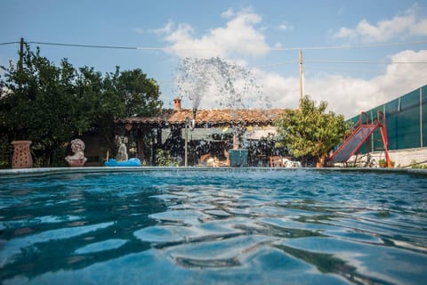 Seasonal outdoor pool, a waterfall pool, pool umbrellas, sun loungers