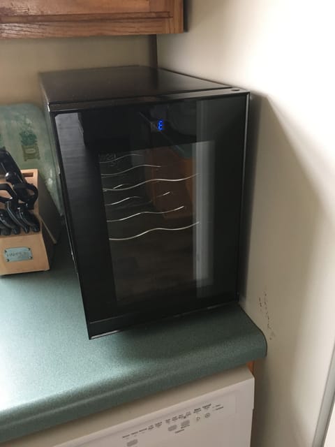 Fully stocked kitchen even has a wine frig!