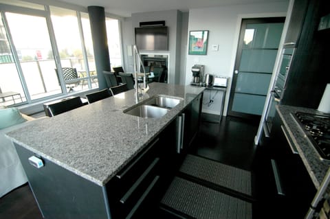 Kitchen: stocked with plenty of glasses, dishes, utensils, stainless steel pots