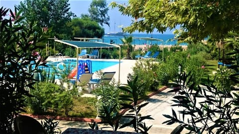 Outdoor pool, a waterfall pool, pool umbrellas, sun loungers