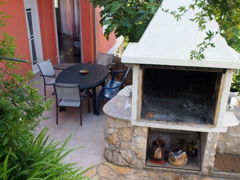Outside fireplace, free to use and entrance to the apartment