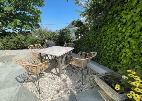 Dining area seats four and has a Weber barbecue.