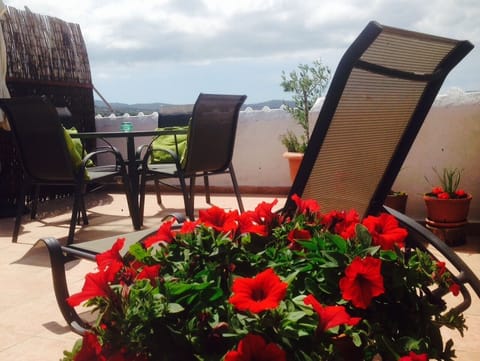 private roof terrace with sunbeds and table with chairs