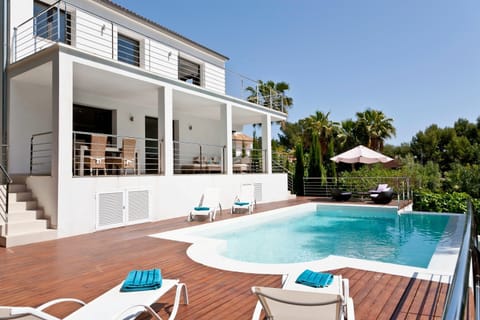 view of villa and pool looking up from deck area
