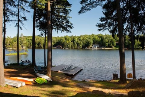 Waterfront with fire pit and dock.