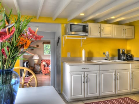 Kitchen with seating area, full sized refrigerator. 