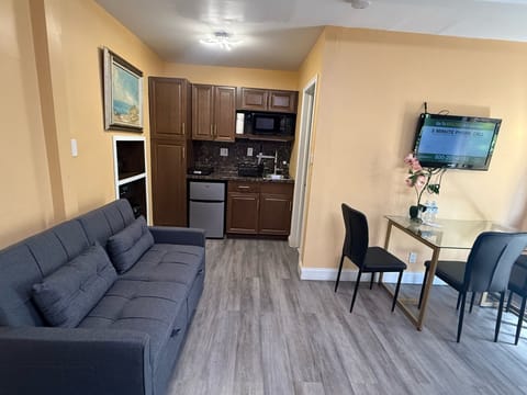 Economy Studio, Multiple Beds, Kitchenette, Garden Area | Living area | 42-inch TV with satellite channels