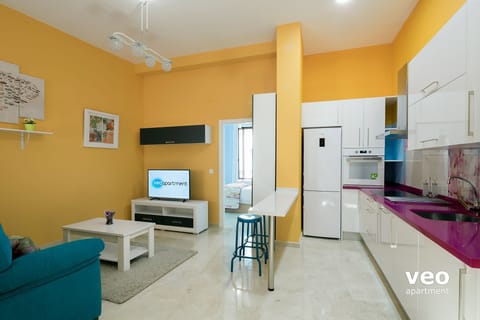 The kitchen is partially separated from the living area by a breakfast bar.