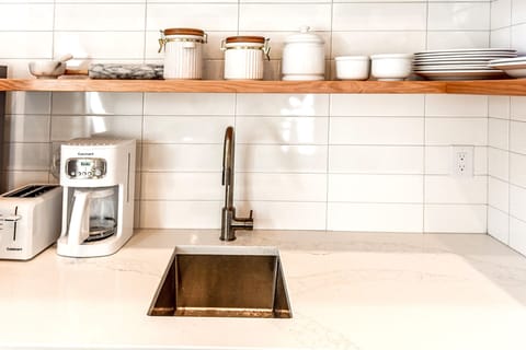 marble counters. stainless appliances. open shelving. 