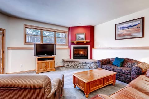 Spacious living room with gas fireplace, flat screen, and fold out couch.