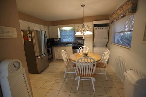 Kitchen has stainless steel appliances, dishwasher, and washer and dryer.