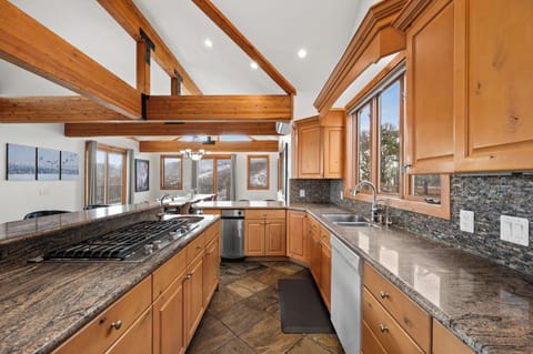 Gourmet kitchen is open to living room and dining