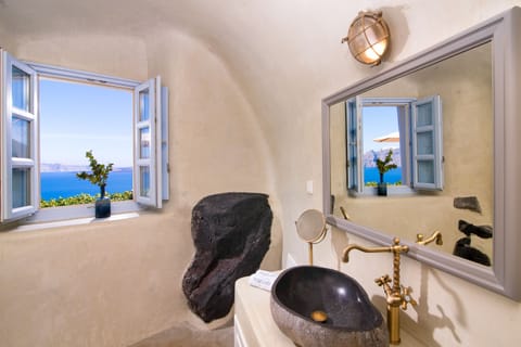 Althaea Honeymoon Cave Suite with Caldera View & Hot Tub | Bathroom | Shower, free toiletries, hair dryer, bathrobes