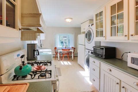 Kitchen w small eating nook, toaster oven, microwave, dishwasher, washer + dryer