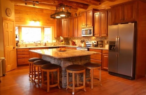 The gourmet kitchen with granite countertops and bar counter with seating for 5.