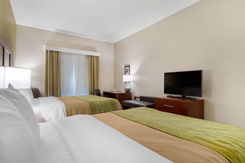 Premium bedding, desk, laptop workspace, blackout drapes