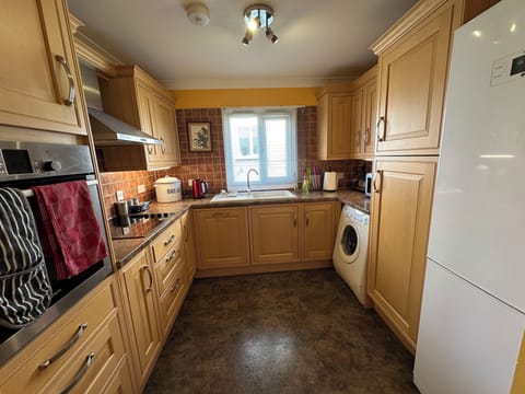 Kitchen with washing machine and large fridge / freezer