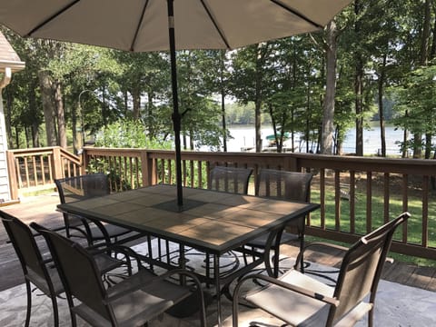 Dine on the lakeside deck with beautiful view of water and fenced yard.