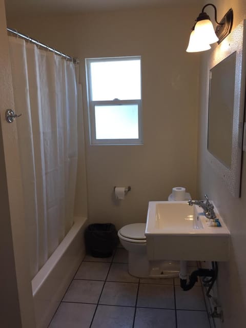 Economy Room | Bathroom | Shower, free toiletries, towels, soap