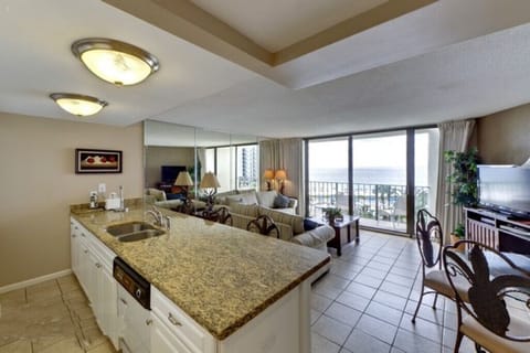 A kitchen with a granite countertop and a spectacular view of the ocean!