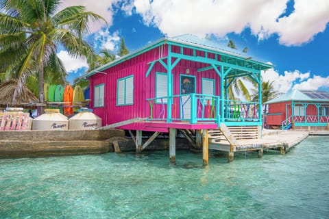 Colorful overwater cabana with stunning Caribbean Sea views in Belize.