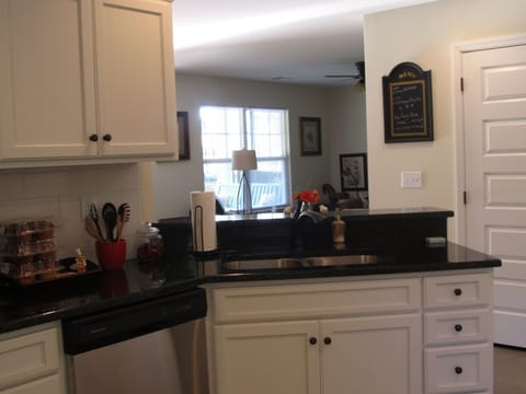Kitchen with granite counter tops and full stocked cabinets.