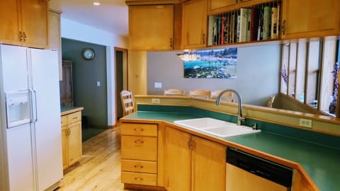 Spacious Custom Kitchen with built-in Seating & Table Opens to All Living Areas.